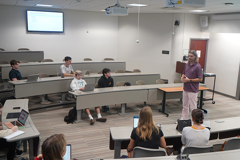 photo of professor Christopher Otten giving a lecture to a BMSI class